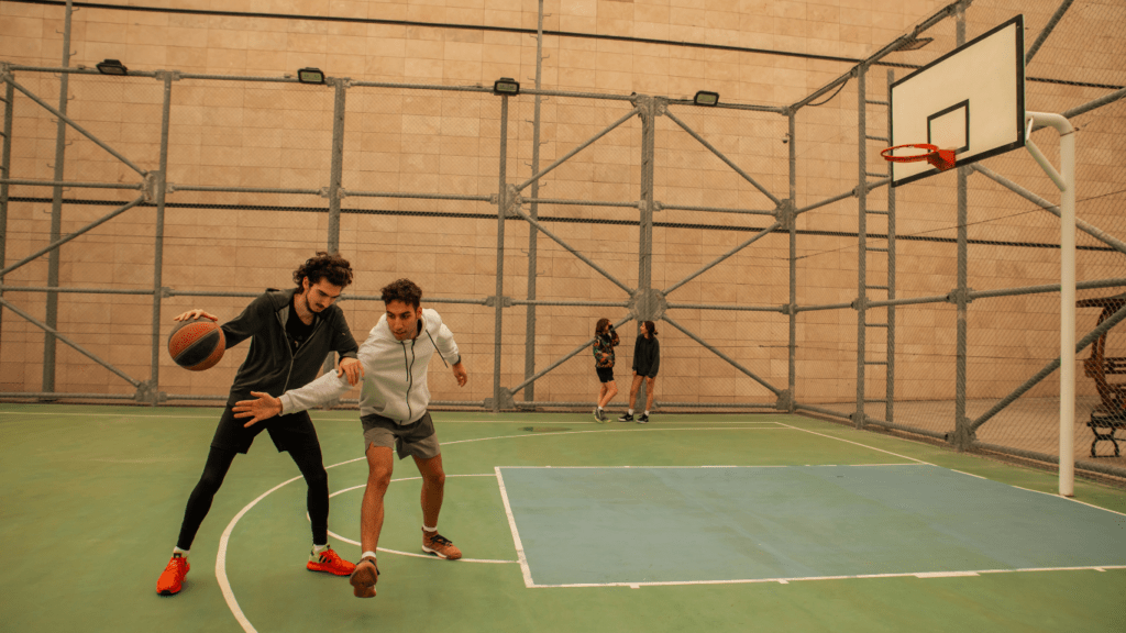 Men playing in basketball court